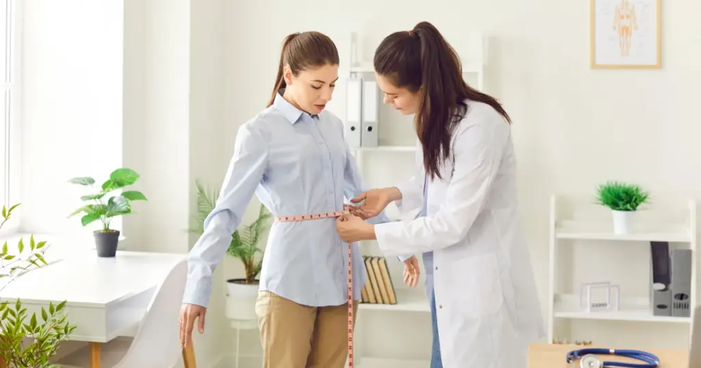 Measuring woman’s waist during Weight Loss in Fredericksburg, VA