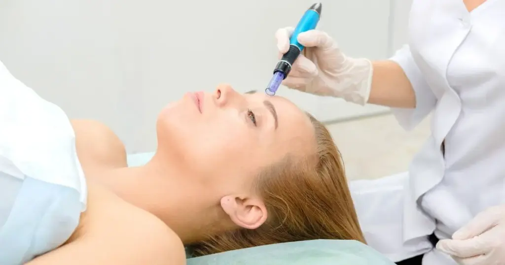 Close-up of a patient examining mild acne scars and blemishes, a common concern addressed by Microneedling for acne scars